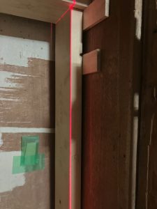 垂直レーザーを照射されるサッシを付ける為のパッキンで垂直を調整した間柱