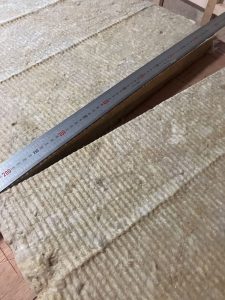50mm厚80Kロックウールを鋼製定規を当てて切断加工